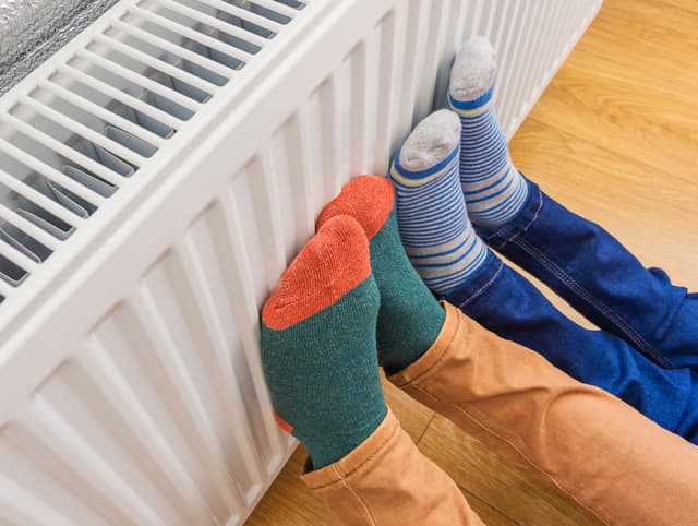 Two pair of feet on radiator